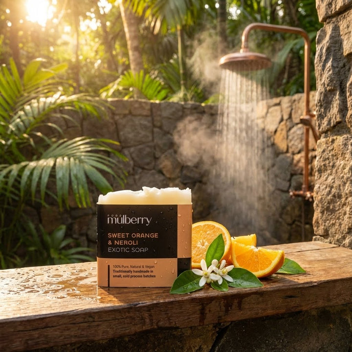 Mullberry soap bar with oranges and leaves on a wooden surface outdoors