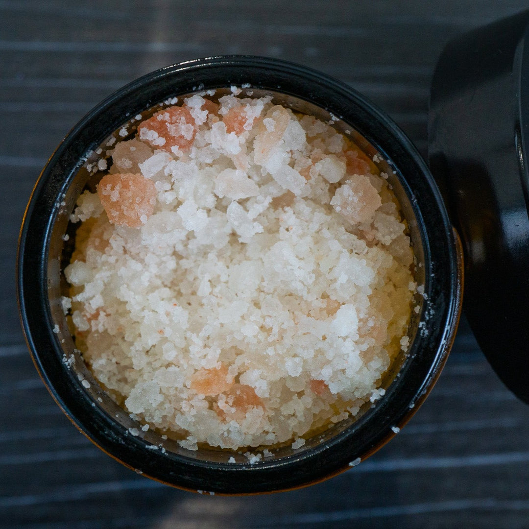 Opened jar of bath salts pink Himalayan and white salts from above