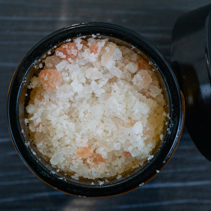 Opened jar of bath salts pink Himalayan and white salts from above